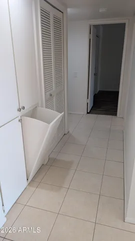 Hallway with built in laundry hamper.