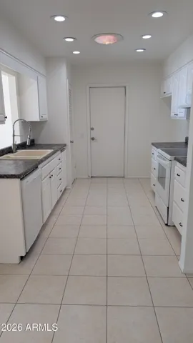 Galley kitchen with pantry.