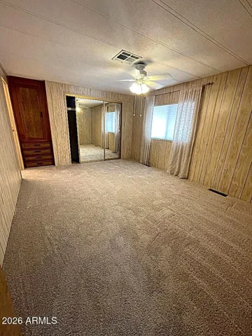 Master bedroom with large mirrored doors closet