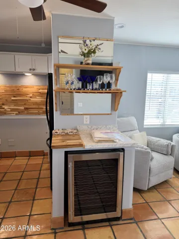 wine fridge and beverage counter with glass storage