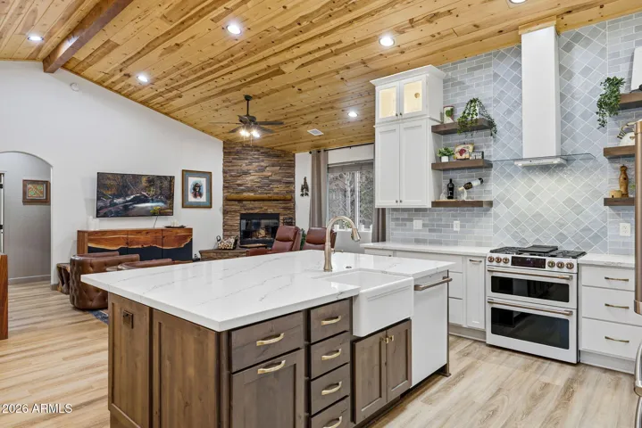 Dark wood island with deep cast iron farmhouse sink with beautiful coordinating faucet.