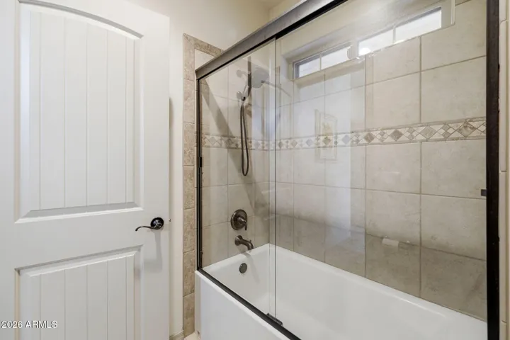 Separate shower/toilet room with class encloser on this tub shower combo