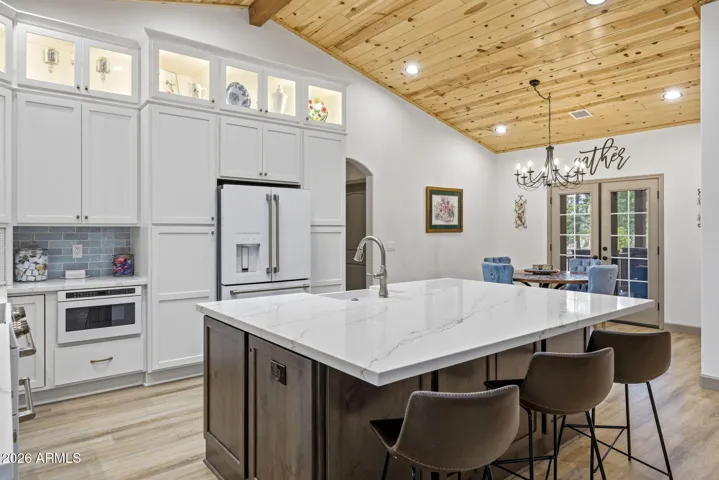 Brand new kitchen with oversized island and Quartz counters, maple cabinets with lighted upper level display