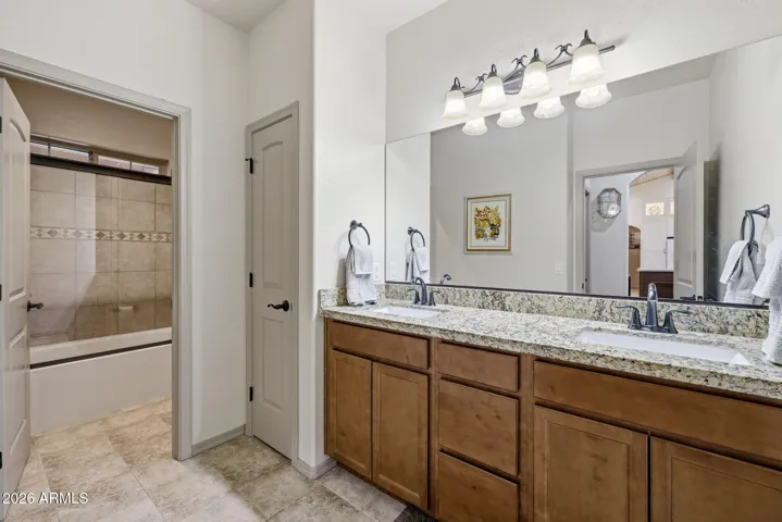 Dual vanity with granite counter tops and linen closet