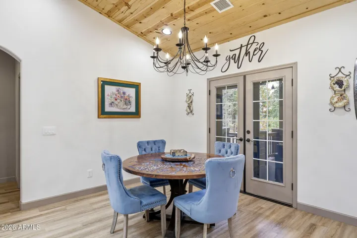 Dining area off the kitchen with French doors open to the covered porch. New Chandelier