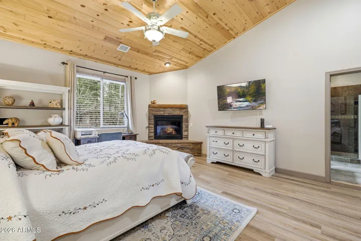 Vaulted ceilings with tongue and groove knotty pine ceiling large enough for office desk and sitting area