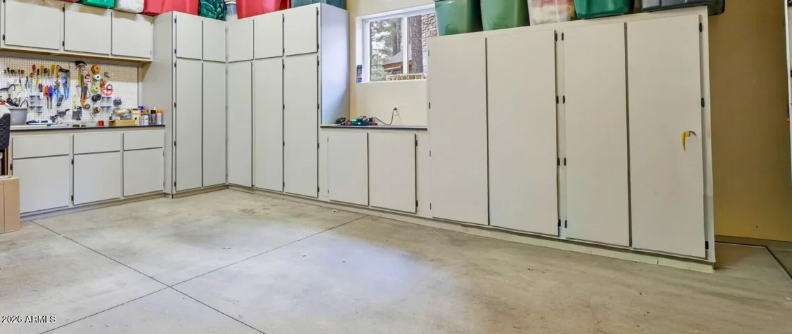 Built in cabinets in 2 car garage with keypad entry and garage door opener