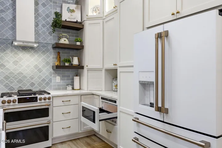 GE Cafe Appliances showcased in new kitchen redesign including open shelving and gas stove.