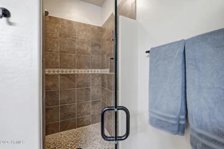Tiled shower with glass door