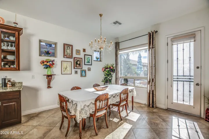 Dining room with windows and door to backyard.
