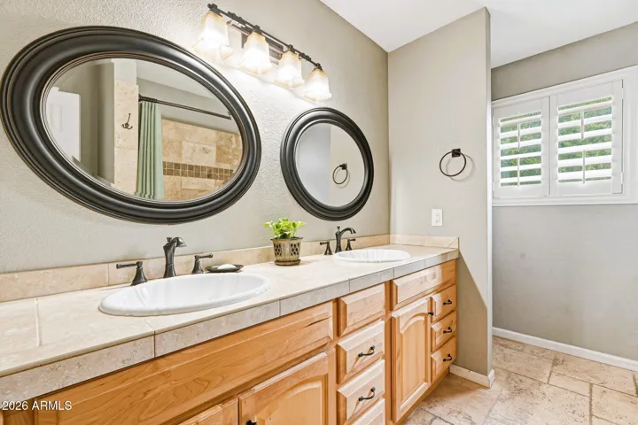 Hall bathroom features two sinks. Remodeled in 2009.