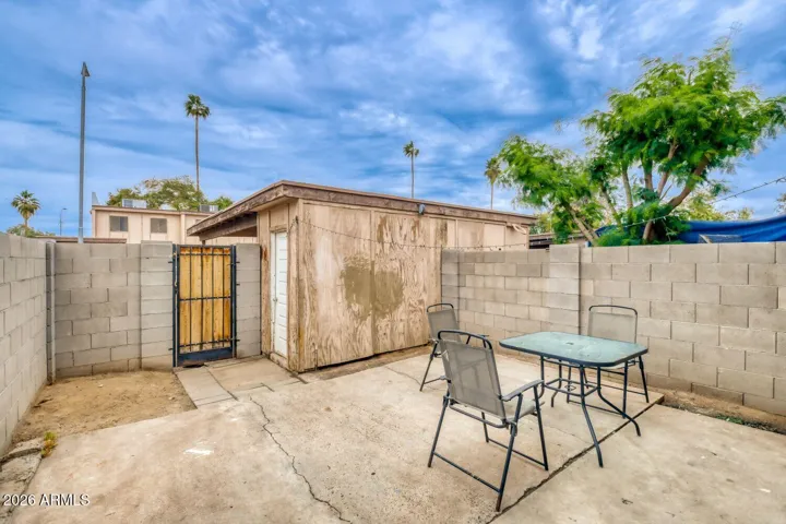 Private patio with block wall fencing, ideal for outdoor seating and simple outdoor living.