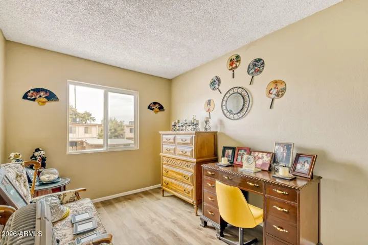 Versatile room with natural light, ideal as a second bedroom, home office, or sitting area.