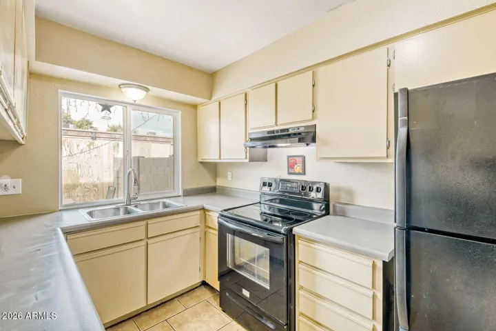 Kitchen window brings in natural light and looks out to the patio