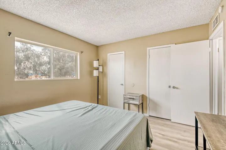 Comfortable primary bedroom with natural light and space for a full bed setup.