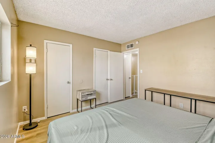 Primary bedroom offers simple layout with closet access and easy flow to the hall bath.