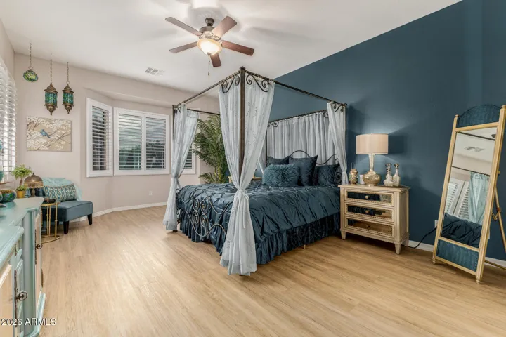 Large primary bedroom with bay window.