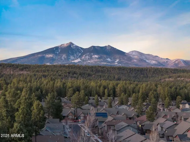 Aerial views capture the stunning San Francisco Peaks above the tree-lined Presidio in the Pines community. Breathtaking mountain scenery and proximity to trails and downtown Flagstaff make this location unbeatable.