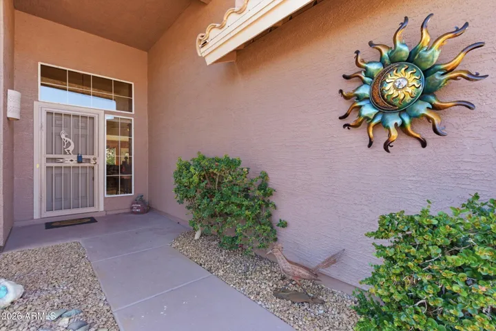 Covered front entry offering shade and a welcoming first impression.