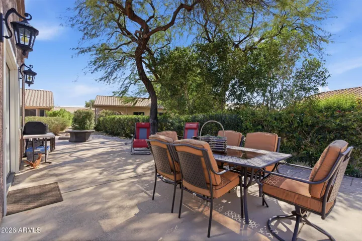 Extended patio surrounded by mature oleanders for added privacy.