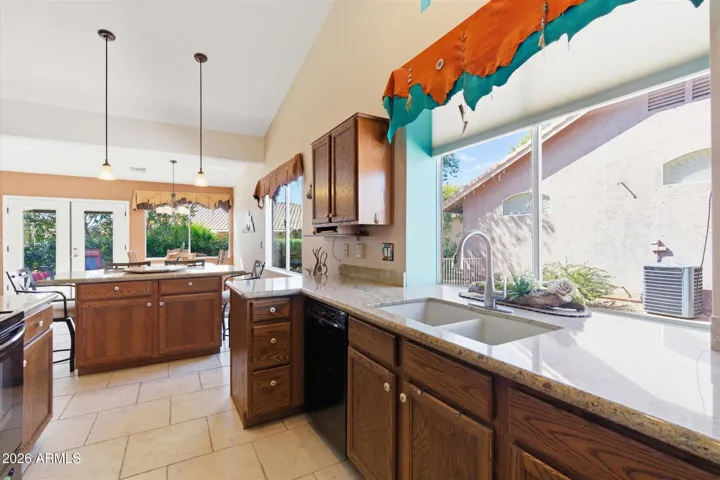 Bright kitchen with granite countertops and abundant natural light.