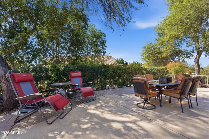 Extended patio surrounded by mature oleanders for added privacy