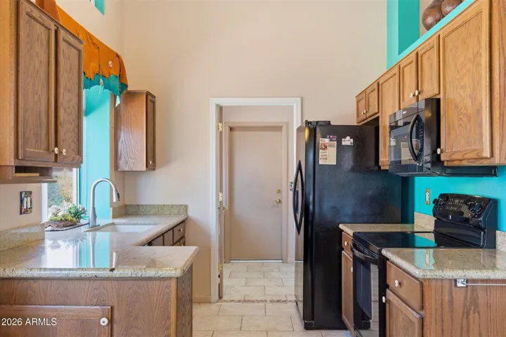 Kitchen window overlooking the side yard area, bringing in natural light and creating a bright, inviting workspace.