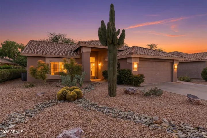 Stunning twilight view highlighting warm exterior lighting and inviting entry.