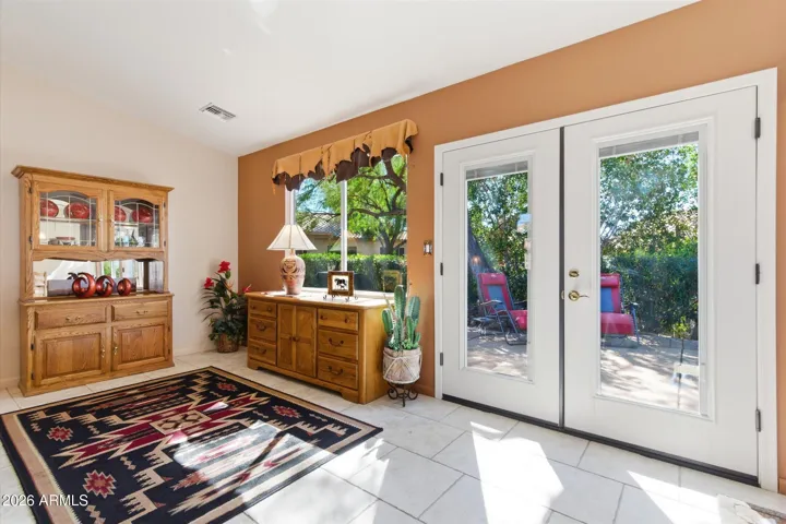 French doors opening to the private backyard patio.