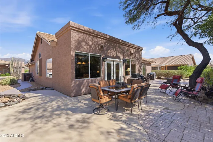 Extended paver patio with outdoor dining table, creating the perfect setting for morning coffee, evening meals, and relaxed backyard entertaining.