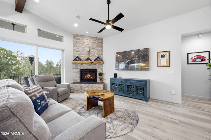 STONE FRONT GAS FIREPLACE WITH CUSTOM WOOD MANTEL