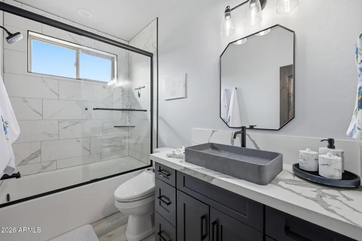 VESEL SINK AND TILED SHOWER FLOOR TO CEILING.