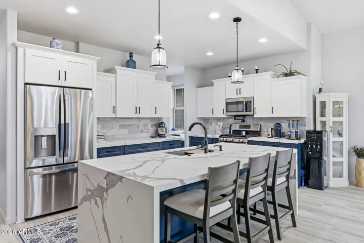 WATER FALL ISLAND COUNTER, SOFT CLOSE CABINETS, UPGRADED STAINLESS APPLIANCE PACKAGE AND MORE....