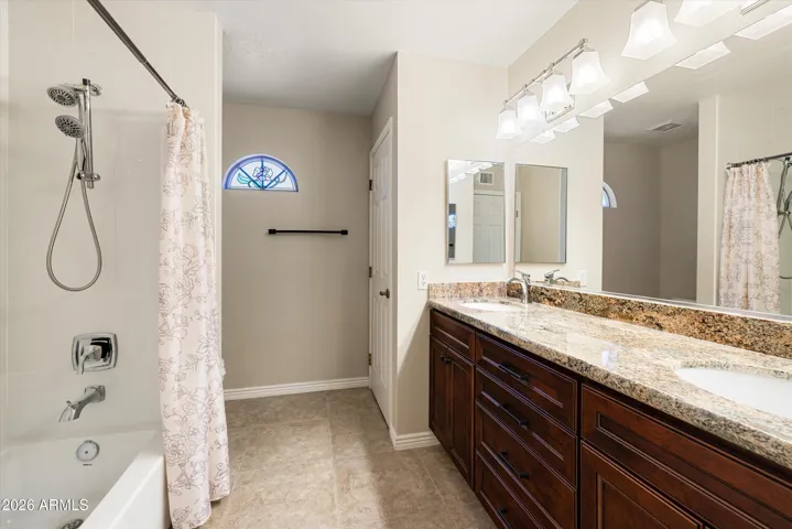 The upstairs hall bath offers a tub/shower combo, dual vanities, and a linen closet.