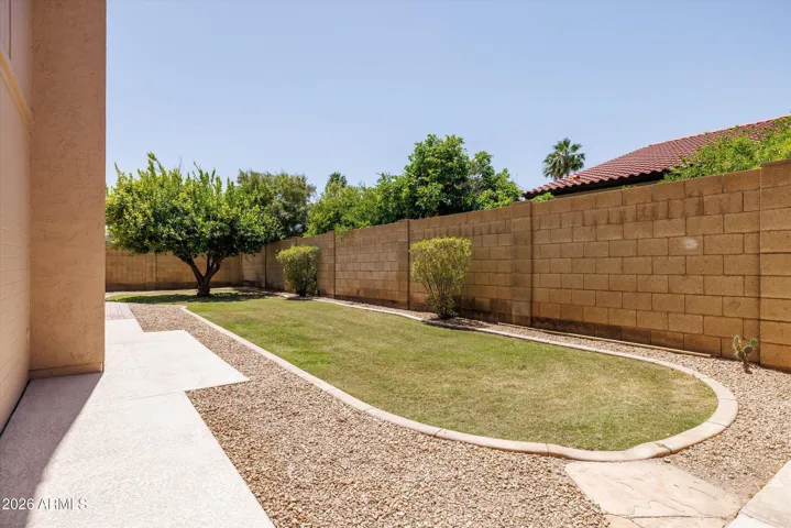 Grassy play area and storage shed on the side yard.