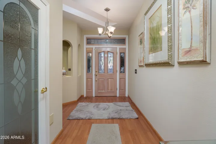 front door and hallway leading to main living area of home