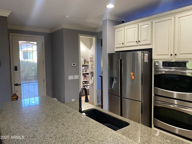 Kitchen looking at Pantry/Coffee Bar and Side Door to Extended Driveway