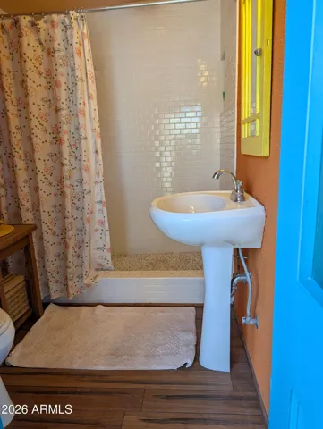 The newly remodeled bath has vinyl plan flooring