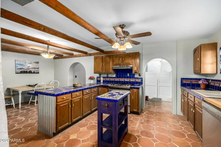 Spanish blue tile and rich wood cabinets.