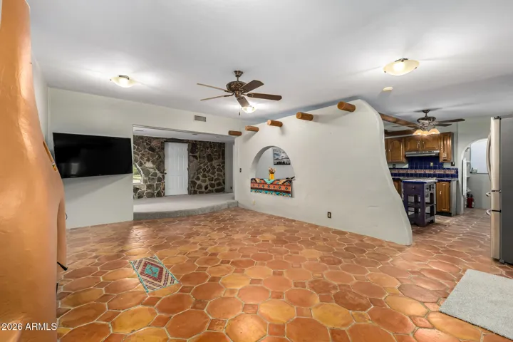 The living room looking into kitchen. Decorative wall divider.