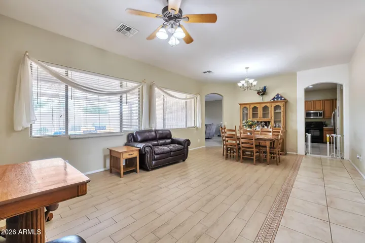 Spacious formal dining area with abundant natural light and tile flooring. This open-concept space flows seamlessly into the living area, perfect for entertaining and everyday living in this Glendale home