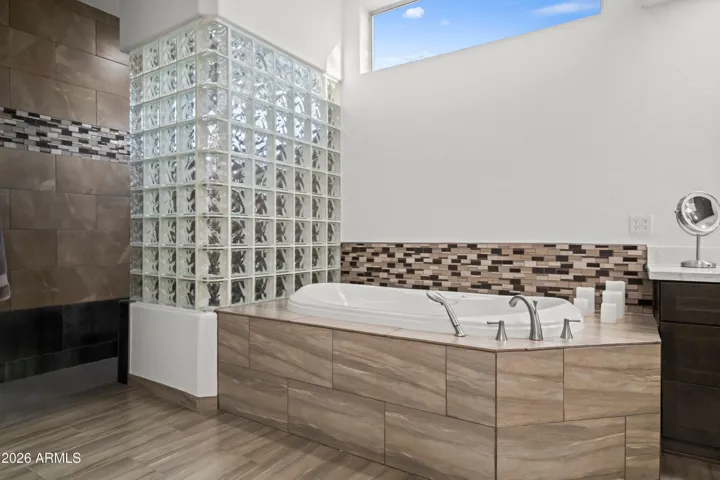 Luxurious Scottsdale bathroom with air jet soaking tub, glass block accents, and spa-like finishes. Perfect for relaxation and everyday comfort.