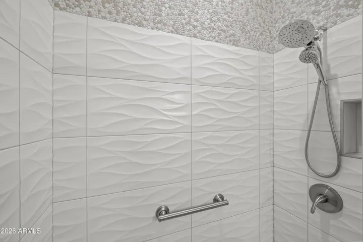 Scottsdale bathroom featuring eye-catching 3D tile accents in the shower. Contemporary finishes and textured design create a luxurious, spa-like feel.