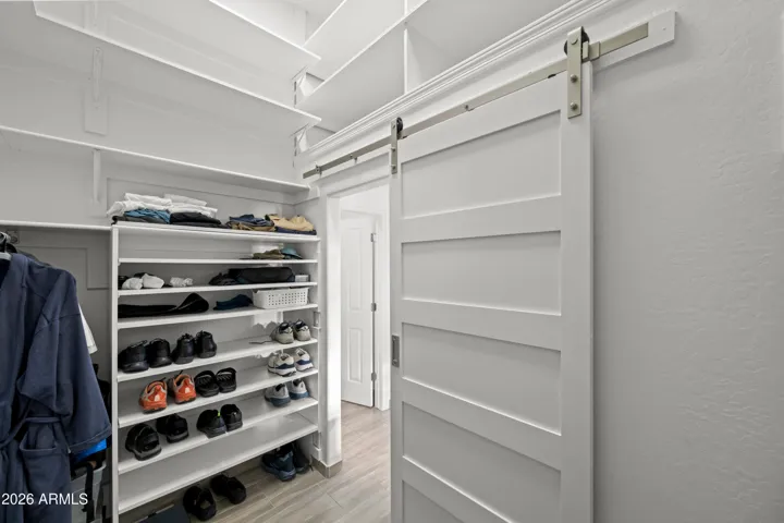 Scottsdale walk-in closet with extensive shelving and dedicated shoe storage. Well-designed space for organization and everyday convenience.
