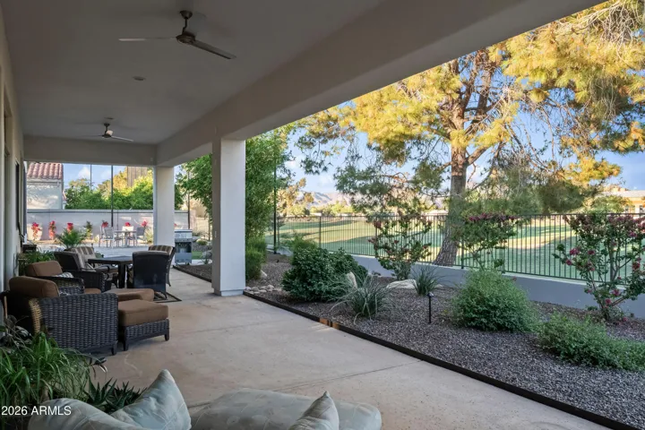 Scottsdale backyard with covered patio overlooking lush landscaping and open views. Perfect space to enjoy Arizona sunsets and outdoor entertaining near the pool.