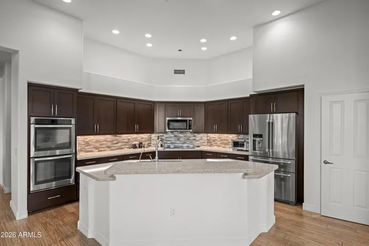 Spacious Scottsdale kitchen island with bar seating, perfect for entertaining and casual dining. Open layout connects seamlessly to living and dining areas.
