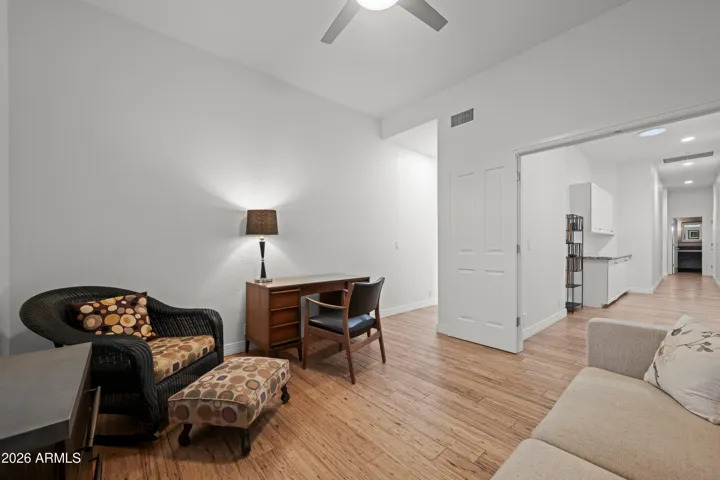 Scottsdale bedroom with wood flooring, ceiling fan, and natural light. Ideal for guests or family with versatile layout and modern finishes.