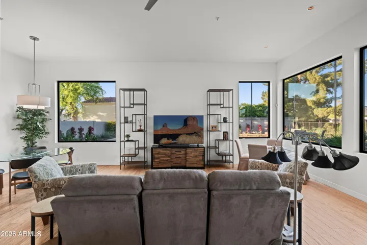 Open-concept Scottsdale living area featuring oversized windows, modern finishes, and natural light throughout. Ideal for entertaining with views of the landscaped yard.