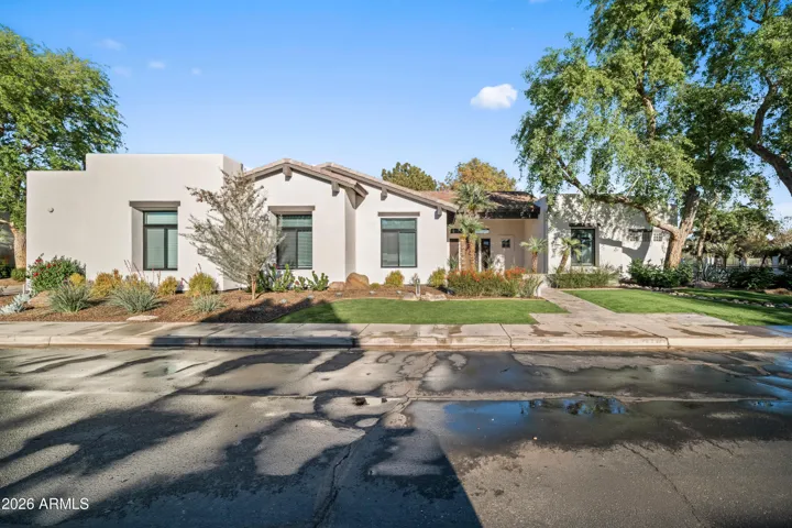 Stunning Scottsdale home exterior featuring modern architecture, clean lines, and desert landscaping. The inviting walkway and updated finishes highlight the home’s upscale design and curb appeal.