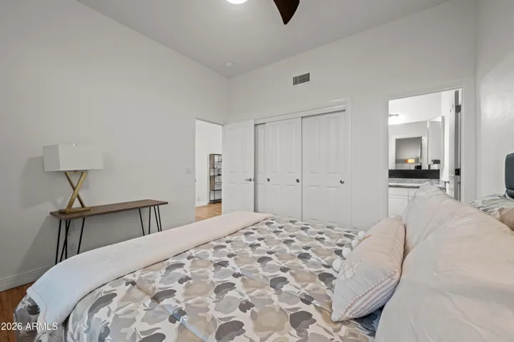 Scottsdale bedroom featuring generous space, wood flooring, and easy access to closet storage and nearby bathroom. Clean and move-in ready design.